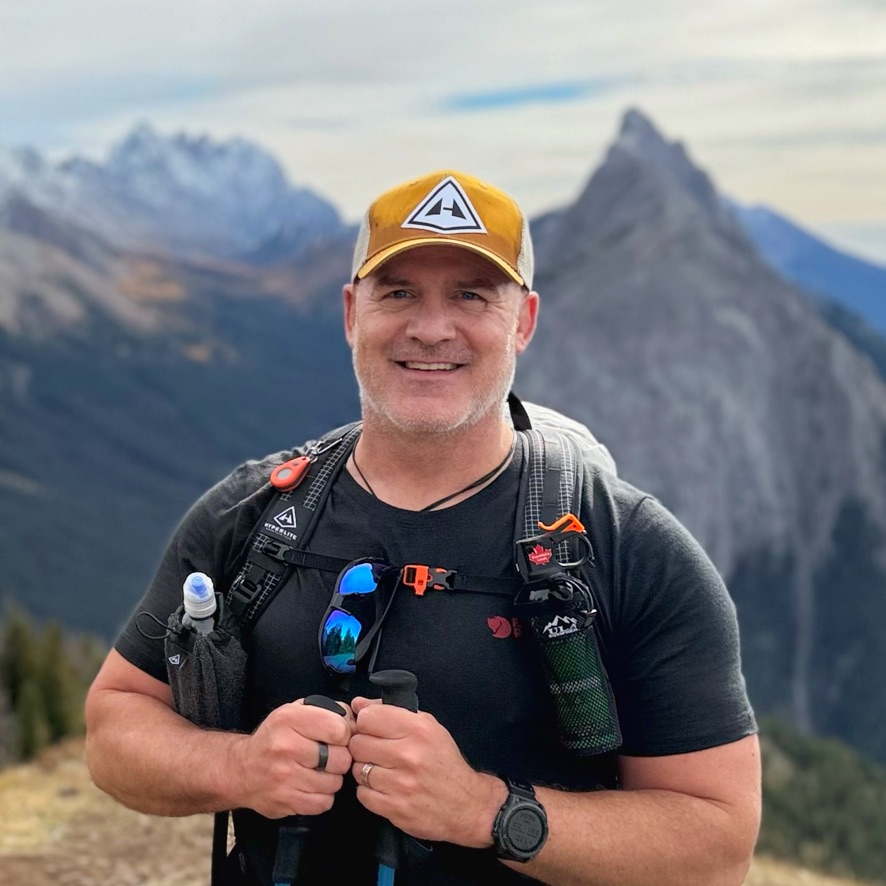 Vince Fowler, smiling, in the mountains